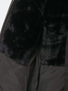 Close-up of black jacket with warm faux fur lining and durable metallic zipper detail