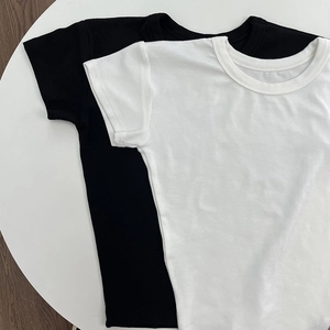 Flat lay detail of black and white modal cotton t-shirts showing high-quality fabric texture