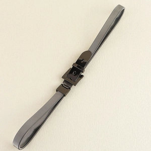 Detailed view of the sleek black alloy square buckle and elastic waist belt texture