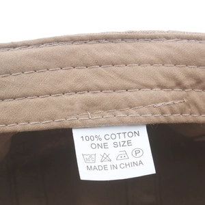 Macro shot of 100% cotton inner label and stitching on khaki breathable baseball cap