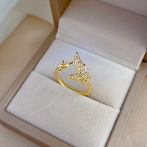 Elegant gold butterfly open ring with zircon inlay presented in a beige velvet jewelry box