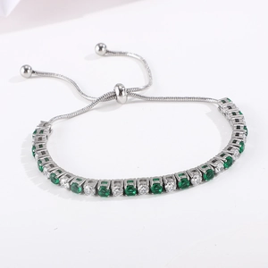 Detail of adjustable tennis bracelet with alternating green and white round cubic zirconia
