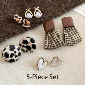 Close-up of a 5-piece earring set featuring pearls and autumn-themed patterns