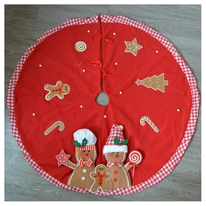 Detail of red plush Christmas tree skirt with 3D gingerbread man and candy cane decor