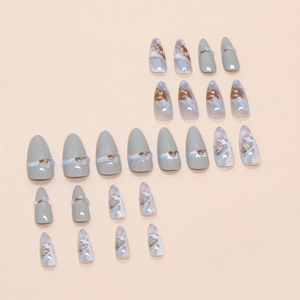 Light blue and marble press-on nails set with gold foil accents and glossy finish