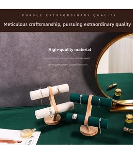 Macro shot of double-tier wooden jewelry stand with velvet bars for bracelet display