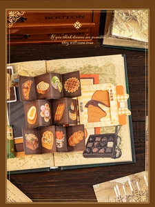 Close-up of vintage bakery stickers with croissant and waffle patterns on retro book pages