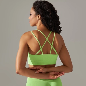 Detail view of fluorescent green ribbed sports bra with criss-cross back straps design