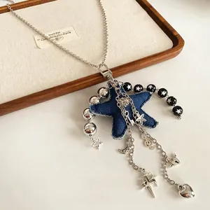 Y2K titanium steel necklace with blue denim star and celestial charms on linen tray