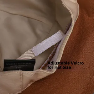 Detailed macro view of the adjustable velcro strap inside the brown linen sun hat