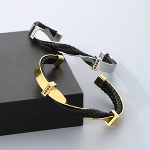 Macro shot of gold and silver twisted titanium steel bangles with black cubic zirconia