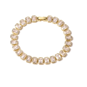 Detailed macro view of a gold-plated bracelet featuring rectangular clear zircon stones