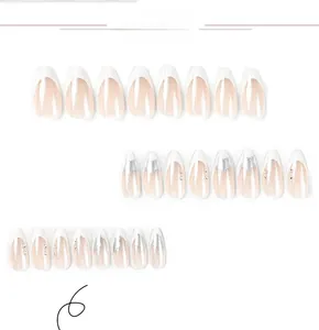 Detailed view of French white tip nails with silver stars and sparkling rhinestones