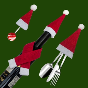 Mini felt Christmas hats and scarves set decorating a wine bottle and cutlery on green backdrop