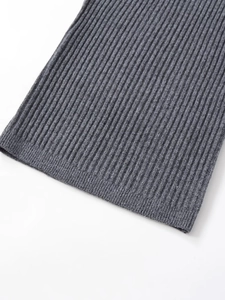 Macro shot of grey ribbed knit fabric texture showing detail of the sleeve hem