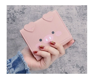 Close-up of pink pig cartoon wallet showing PU leather texture and heart-shaped ears