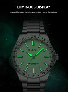 Detailed macro view showing the green luminous display of the quartz watch in the dark