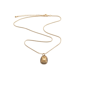 Golden snake chain necklace with oval Buddha pendant and black stone inlay on white background