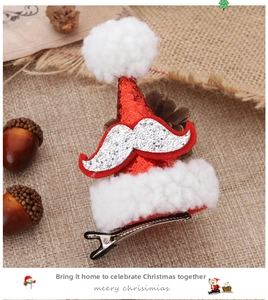 Detail of red sequin Christmas hat hair clip with white fur ball and metal duckbill clip