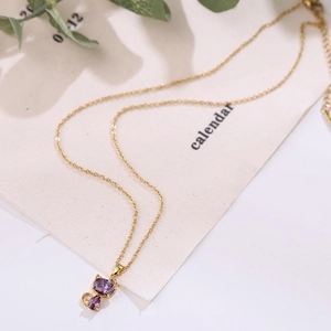 Titanium gold necklace with purple feline pendant and faceted stones for women
