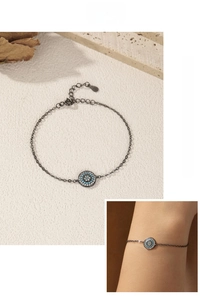 Detail of S925 silver gunmetal bracelet with turquoise pendant on wrist and stone