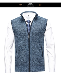 Detail of blue-gray knit vest featuring a stand collar, zipper, and textured fabric
