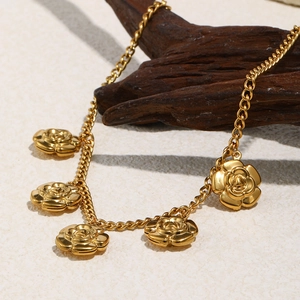 Detail of five 18K gold plated rose flower pendants on a curb chain necklace for women