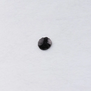 Macro detail of 10mm round black resin cabochon with layered fish scale texture