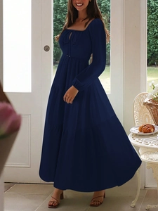Detail view of a navy blue long-sleeved tiered dress with square neck and tie-up details