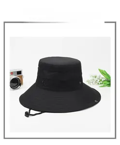 Detail of black wide-brim sun hat with mesh vents and adjustable chin strap