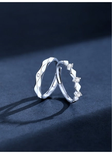 Macro detail showing geometric faceted s925 silver couple rings with sparkling diamonds