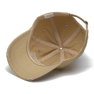 Detail view of khaki distressed baseball cap showing 100% cotton lining and adjustable strap
