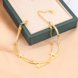 Double-layer gold plated snake chain bracelet with star pendants on a jewelry display box