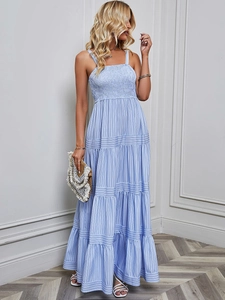 Detail view of the blue and white striped maxi dress featuring a smocked bodice and tiered hem