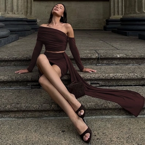 Detail of wine red off-shoulder top and ruched mini skirt with a long side trail
