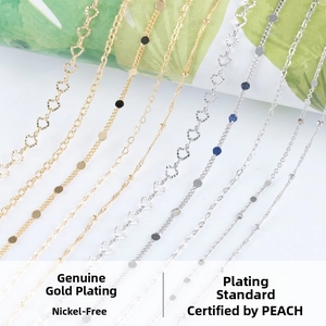 Detail of nickel-free real gold plated chains with heart and disc charms for DIY jewelry