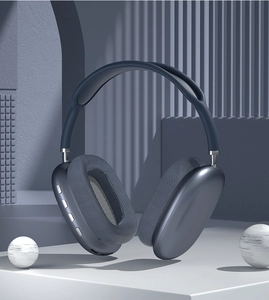 Blue wireless over-ear headphones floating against a minimalist architectural background