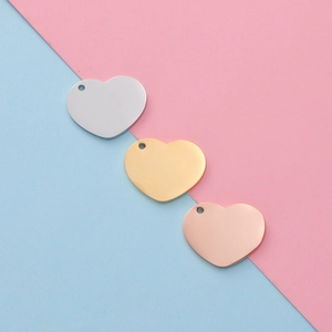 Polished stainless steel heart pendants in silver, gold and rose gold on a split background