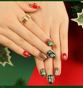 Macro detail of Christmas press-on nails featuring festive trees, snowflakes and gift patterns