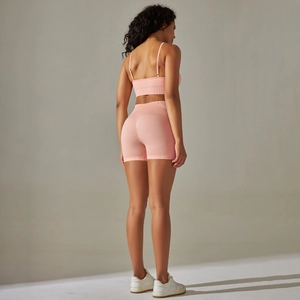 Detailed back view of seamless pink yoga set with cross-back bra and high-waist shorts