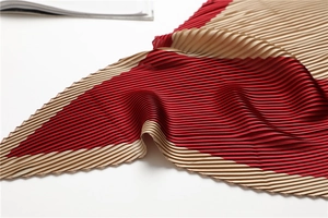 Detail view of red and champagne gold pleated scarf with fine accordion pleats texture