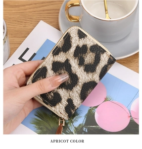 Close-up of leopard print accordion card wallet in apricot with gold zipper detail