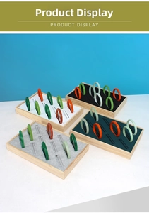 Detailed top view of solid wood jewelry trays displaying colorful jade bangles