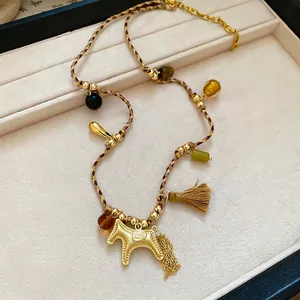 Bohemian woven rope necklace with a gold pony pendant, tassels, and colorful beads