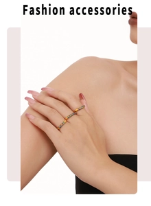 Close-up of three 18K gold-plated rings with colorful cubic zirconia worn by a model