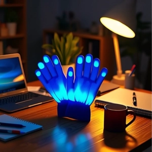 Close-up of LED glowing gloves with blue light fingertips on a desk background