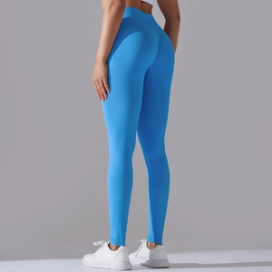 Detail of high-waist seamless knitted sky blue yoga leggings showing fabric texture and fit