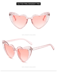 Close-up of glitter pink heart sunglasses with gradient lenses in dual angle view