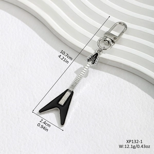 Creative guitar keychain accessory in black and silver enamel finish on white background
