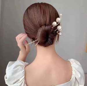 Elegant pearl hair pin with gold metal rod for modern minimalist bun hairstyles